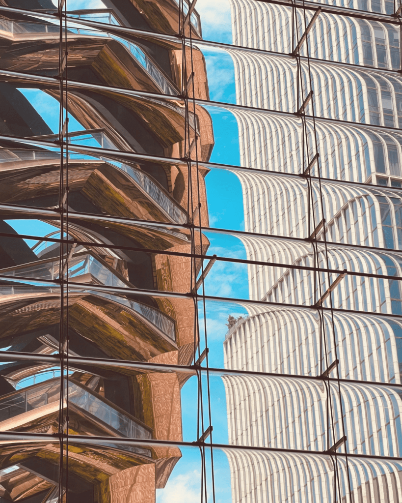Reflected architecture creating layered perspectives, illustrating the distinction between observation and interpretation.