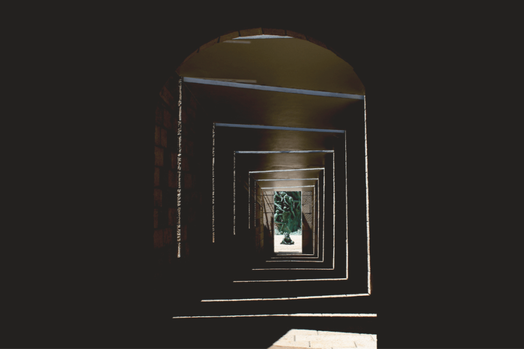 A sequence of architectural frames leading towards an opening, representing transition from understanding towards different functioning.